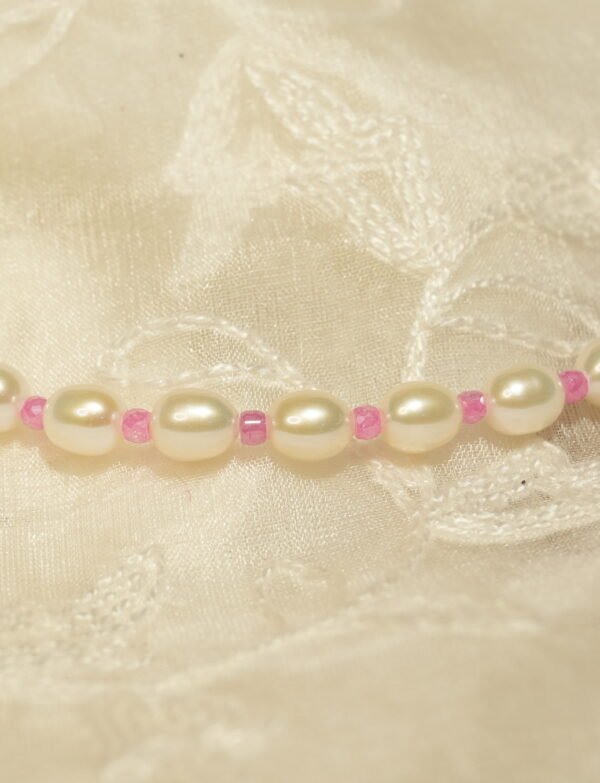 white and pink necklace